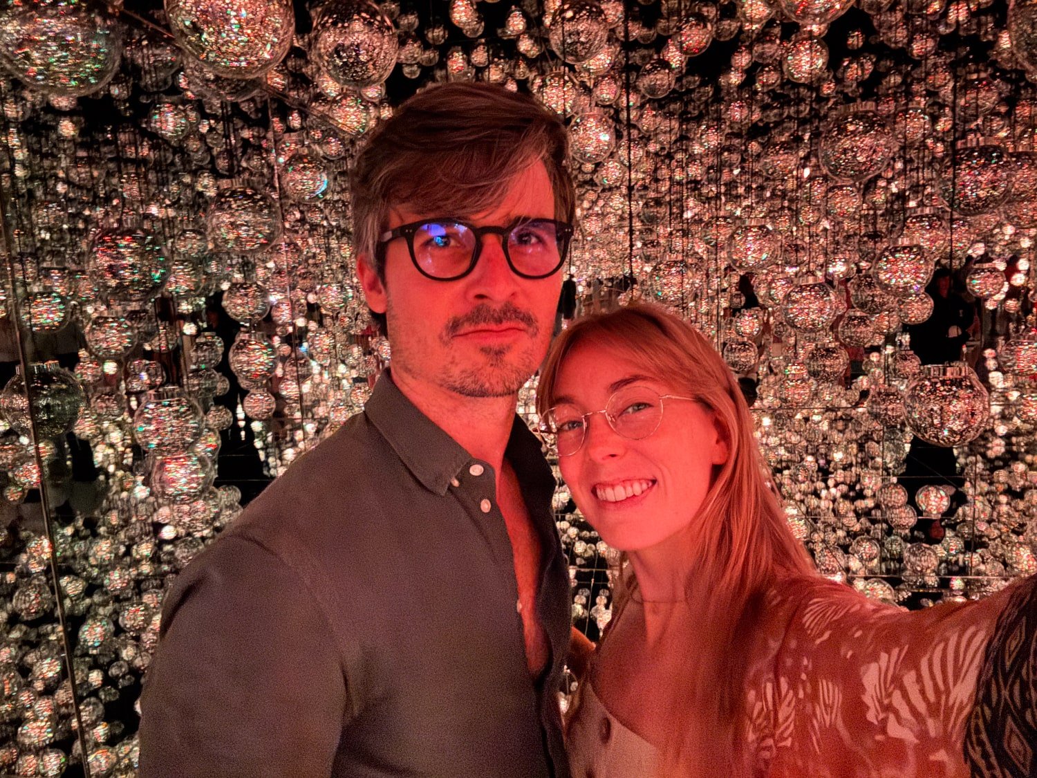 A travel couple take a selfie inside the crystal ball room at teamLab Borderless art museum in Tokyo, Japan.